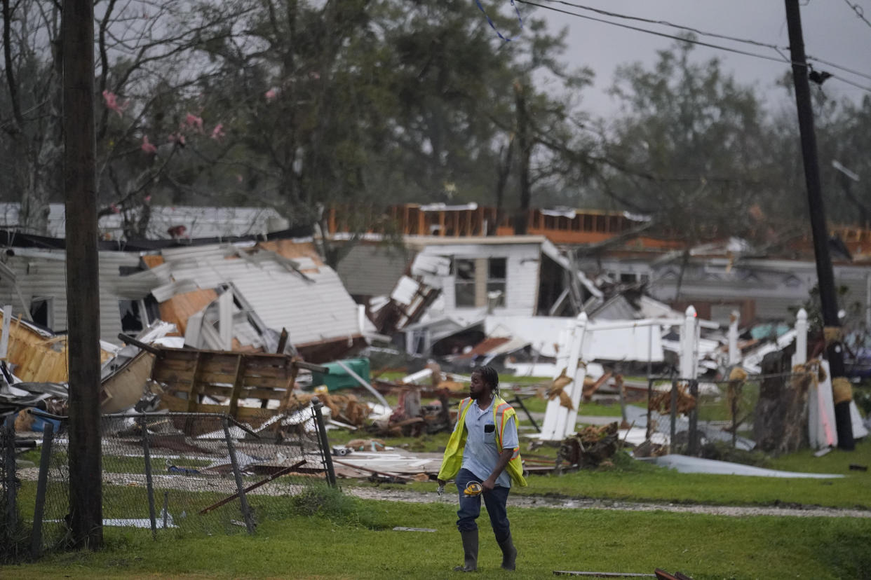 An Atmos Energy employee checks on gas lines after a tornado tore through the area in Killona, La., about 30 miles west of New Orleans in St. James Parish, Wednesday, Dec. 14, 2022. (AP Photo/Gerald Herbert)