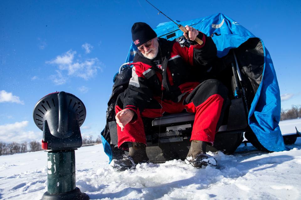 Angler Gary Schuller of Millcreek Township, fishes on ice at Misery Bay in Presque Isle State Park.