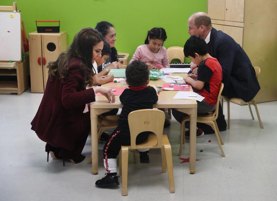 Britain’s Prince William, Prince of Wales, and Catherine, Princess of Wales, engage with children in the Young Mothers program during a visit to Roca Inc (POOL/AFP via Getty Images)