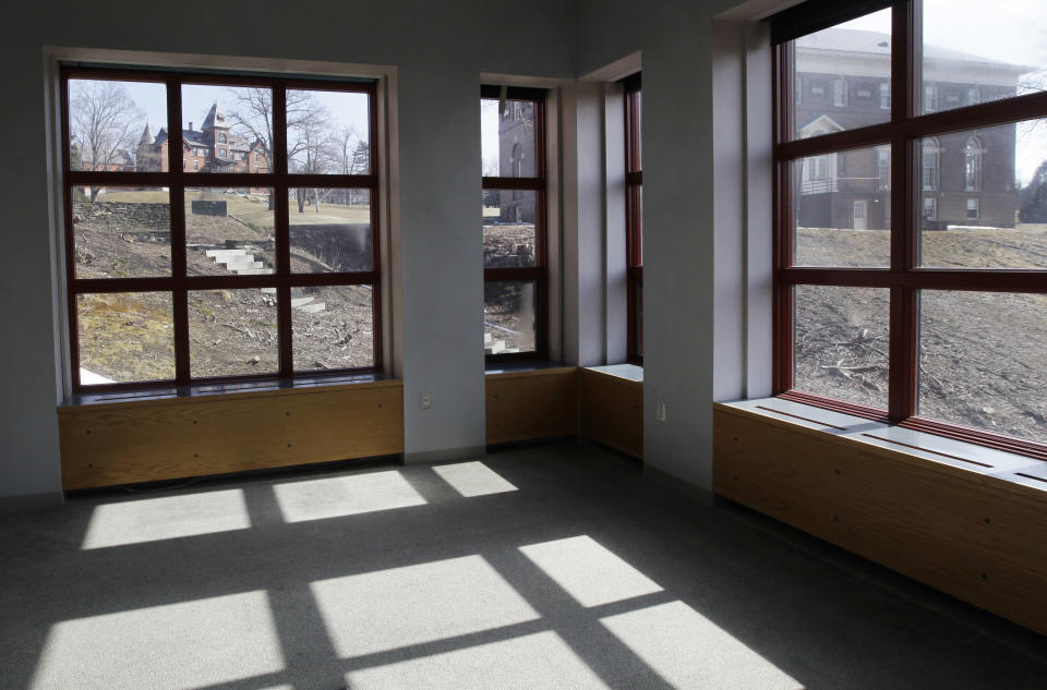 A view through windows in an empty library room looks out onto an historic 217-acre campus in Northfield, Mass. in this photo taken Thursday, March 8, 2012. The campus, along with its 43 buildings, is being offered for free to an orthodox Christian group who can come up a solid plan to use it. (AP Photo/Elise Amendola)