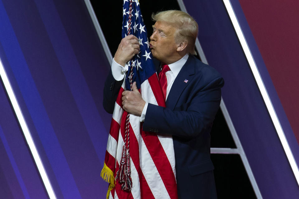 President Donald Trump kisses the American flag after speaking at Conservative Political Action Conference, CPAC 2020, at the National Harbor in Oxon Hill, Md., Saturday, Feb. 29, 2020. (AP Photo/Jose Luis Magana)