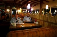 Retired Senior Volunteer Patrol member Steve Rubin (L) and Henry Miller grab a late meal at a restaurant while out on patrol in San Diego, California, United States March 10, 2015. (REUTERS/Mike Blake)
