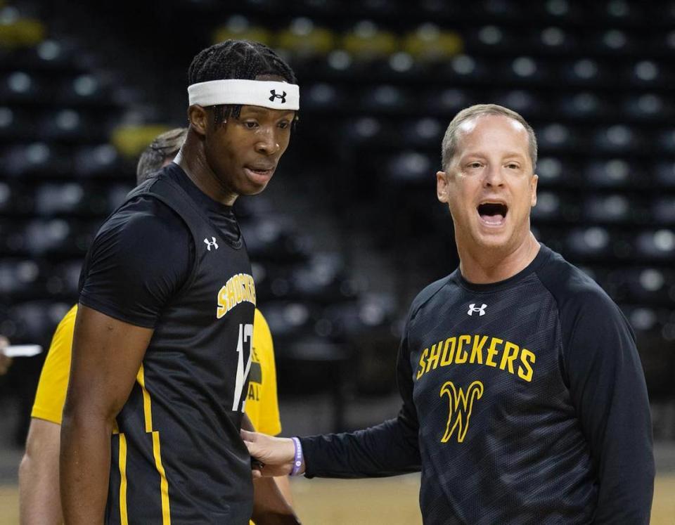 Wichita State true freshman Joy Ighovodja (left) said he appreciates how hard coach Paul Mills (right) pushes him in practice.