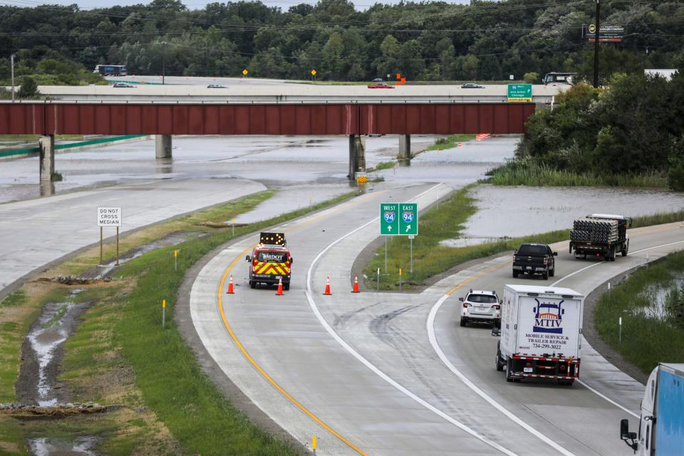 Traffic is redirected from the Interstate 94 and Interstate 275 interchange after overnight flooding left vehicles stranded near the Detroit Metropolitan Airport on Thursday, Aug. 24, 2023.