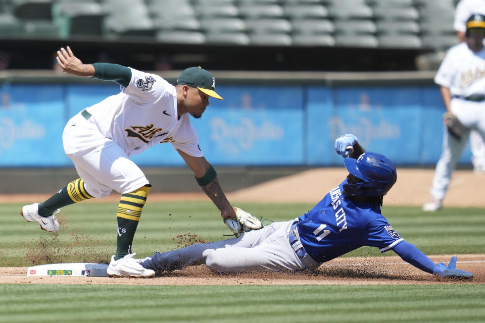 Oakland Athletics third baseman Jordan Diaz, left, tags out Kansas City Royals' Maikel Garcia (11) trying to steal third base during the third inning of a baseball game in Oakland, Calif., Wednesday, Aug. 23, 2023. (AP Photo/Jeff Chiu)