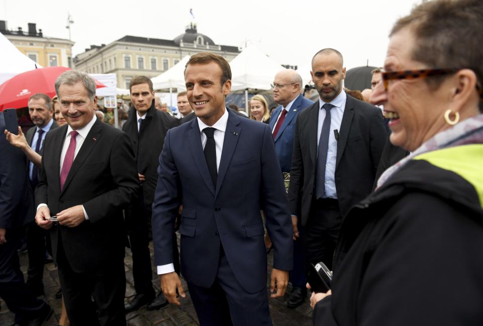 Finland President Sauli Niinisto, left, and French President Emmanuel Macron walk outside the Presidential Palace after their joint press conference in Helsinki, Finland, Thursday Aug. 30, 2018. President Macron is in Finland on a two-day official visit. (Antti Aimo-Koivisto/Lehtikuva via AP)