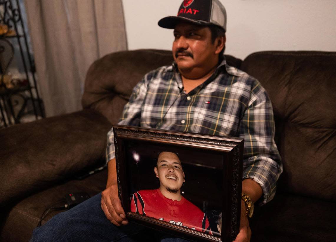 Berman de Paz Gonzalez holds a photo of his son, Berman Daniel de Paz-Martinez, who was taken off life support at JPS Hospital on April 1, 2018.