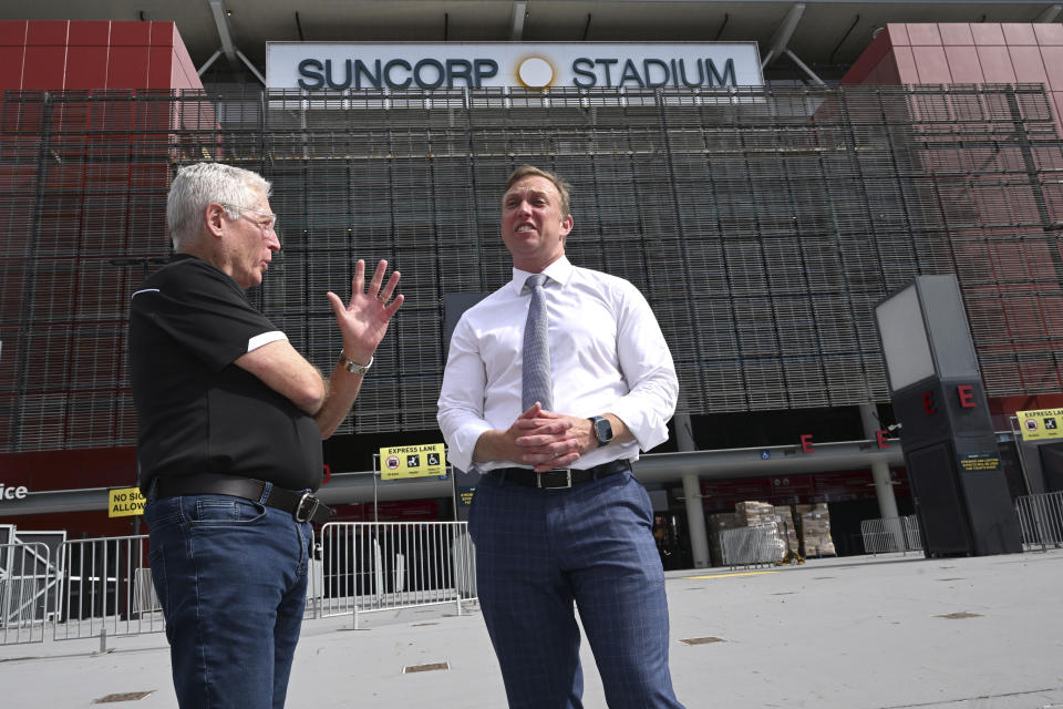 Suncorp Stadium general manager Alan Graham, left, and Queensland state Premier Steven Miles stand in front of the stadium in Brisbane, Australia, Monday, March 18, 2024. Brisbane Olympics organizers have scrapped plans to demolish and rebuild an iconic cricket ground as the centerpiece of the 2032 Games while also rejecting a review panel's recommendation for a new stadium in city parklands. (AAP Image/Darren England)
