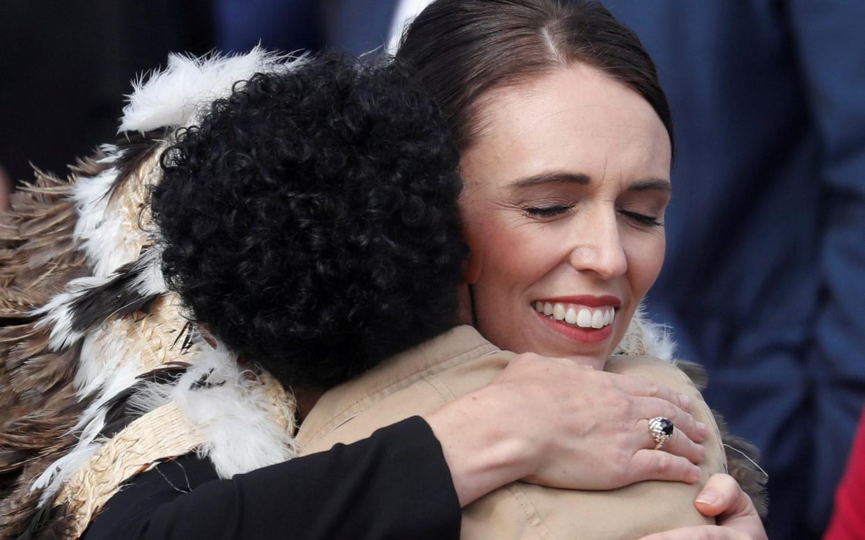 New Zealand's Prime Minister Jacinda Ardern hugs a victim's relative during the national remembrance service for victims of the mosque attacks, at Hagley Park in Christchurch - REUTERS