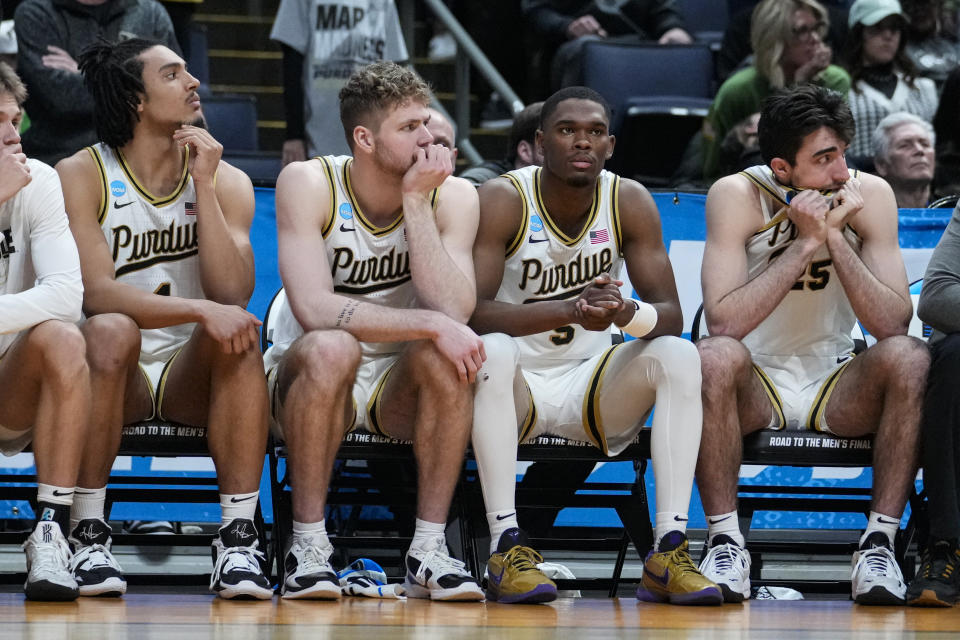 Purdue players, left to right, Trey Kaufman-Renn, Caleb Furst, Brandon Newman and guard Ethan Morton (25) sit on the bench in the closing seconds of the second half of a first-round college basketball game against Fairleigh Dickinson in the men's NCAA Tournament in Columbus, Ohio, Friday, March 17, 2023. Fairleigh Dickinson defeated Purdue 63-58. (AP Photo/Michael Conroy)