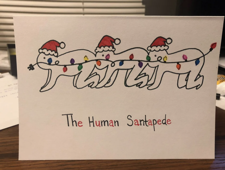 Three people wearing Santa hats with their mouths on the butt of the person in front of them, with text that says "The Human Santapede"