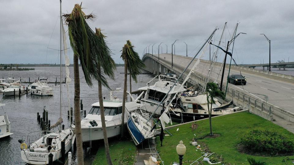 Boats are pushed up on a causeway after Hurricane Ian passed through the area on September 29, 2022 in Fort Myers, Florida. The hurricane brought high winds, storm surge and rain to the area causing severe damage.