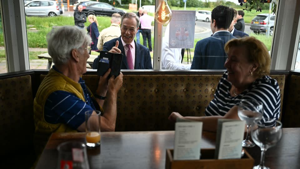 Farage campaigning in Clacton. The Reform leader uses divisive language on migration, warning supporters of what he calls an "invasion" of asylum seekers. - BEN STANSALL/AFP/AFP via Getty Images