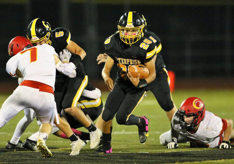 Enterprise's Davion Welch (28) breaks away from Chico players to run for a first down in the third quarter on Friday, Oct. 29, 2021.