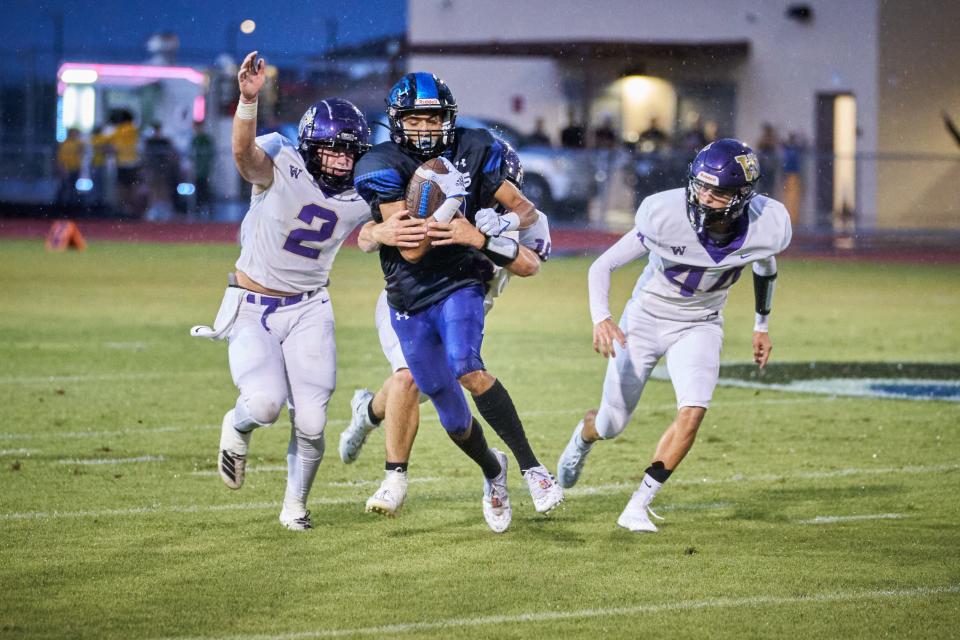 Paradise Honors junior wide receiver Josh Morales (17) runs the ball while being pursued by Wickenburg junior offensive linebacker Trace Buchert (2) senior cornerback Luke Drescher (44) at Paradise Honors High football field in Surprise on Aug. 19, 2022.