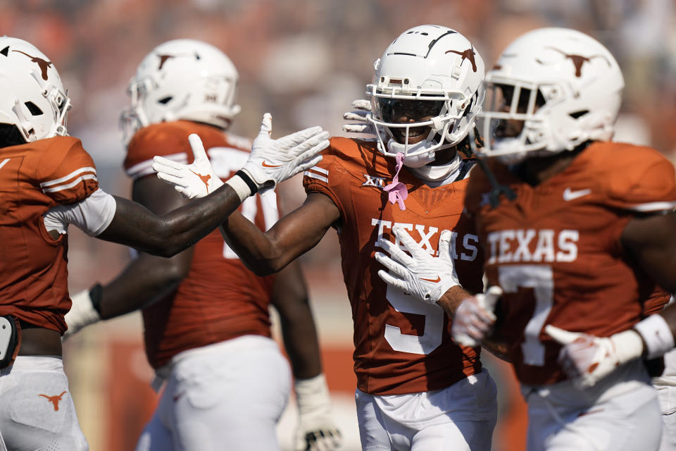 Texas wide receiver Adonai Mitchell (5) celebrates with teammates after catching a pass for a touchdown against Rice during the second half of an NCAA college football game in Austin, Texas, Saturday, Sept. 2, 2023. (AP Photo/Eric Gay)