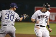 Arizona Diamondbacks' Tim Locastro (16) gets safely back to first base as San Diego Padres first baseman Eric Hosmer (30) applies a late tag on a pickoff-attempt during the first inning of a baseball game Friday, Sept. 27, 2019, in Phoenix. (AP Photo/Ross D. Franklin)