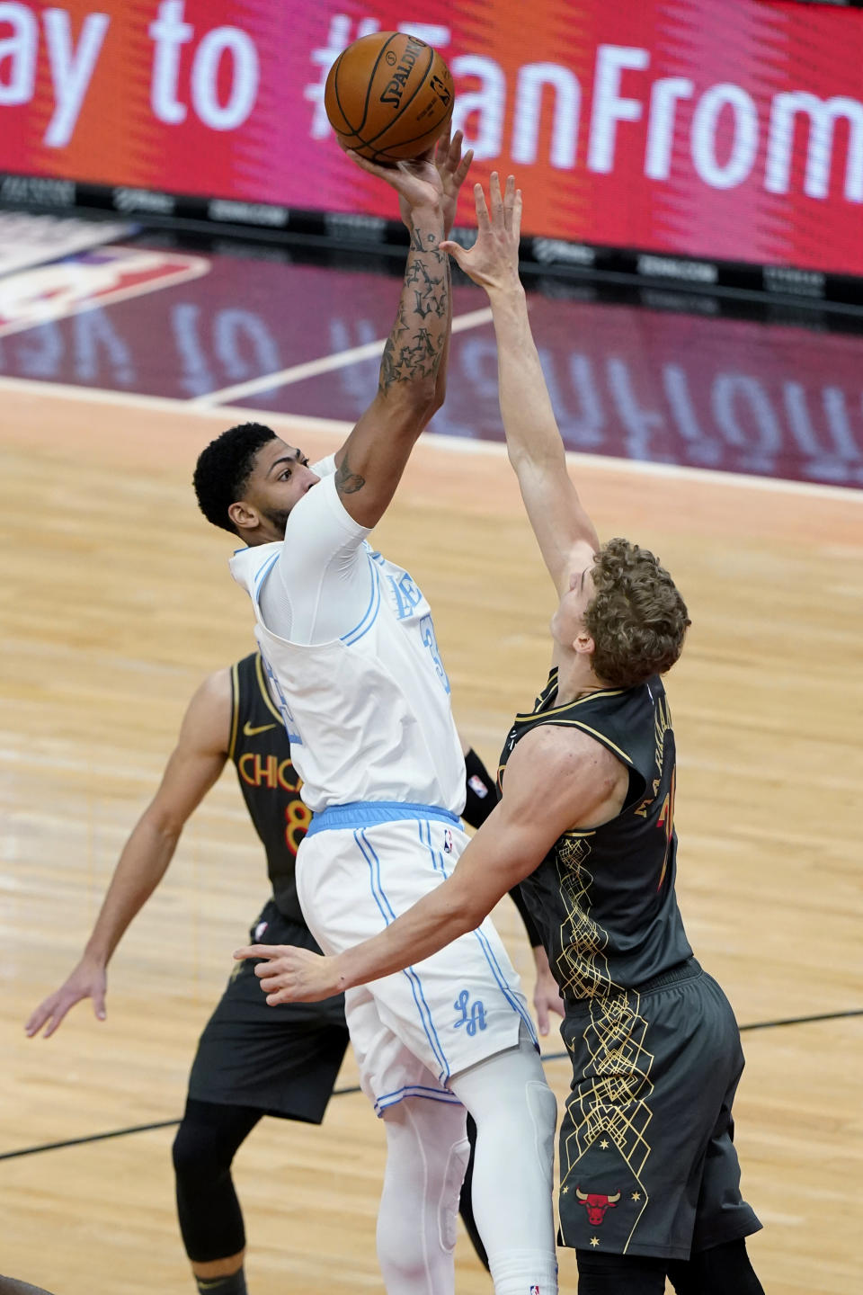 Los Angeles Lakers forward Anthony Davis, left, shoots over Chicago Bulls forward Lauri Markkanen during the second half of an NBA basketball game in Chicago, Saturday, Jan. 23, 2021. (AP Photo/Nam Y. Huh)