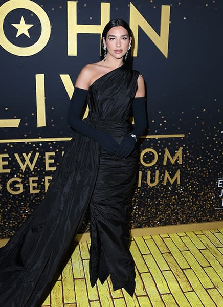 Dua Lipa Wearing An Asymmetric Gown At The Elton John Concert