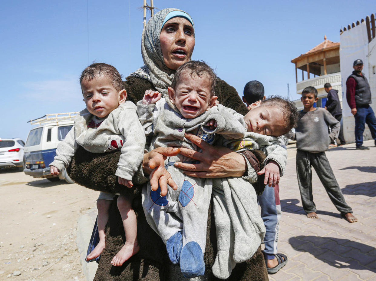 Palestinian woman Nuzha and her triplets forced to move south after Israeli attacks (Ashraf Amra / Anadolu via Getty Images)