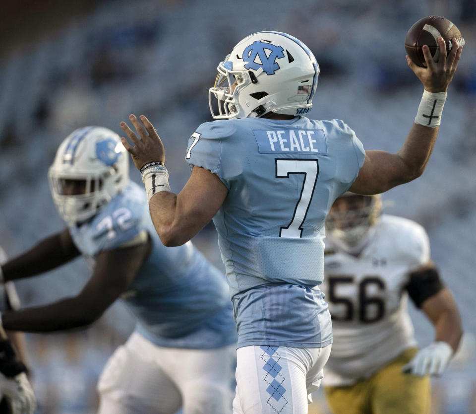 North Carolina quarterback Sam Howell (7), who has the word "Peace" as his nameplate, throws a pass against Notre Dame during an NCAA college football game, Friday, Nov. 27, 2020, at Kenan Stadium in Chapel Hill, N.C. (Robert Willett/The News & Observer via AP)