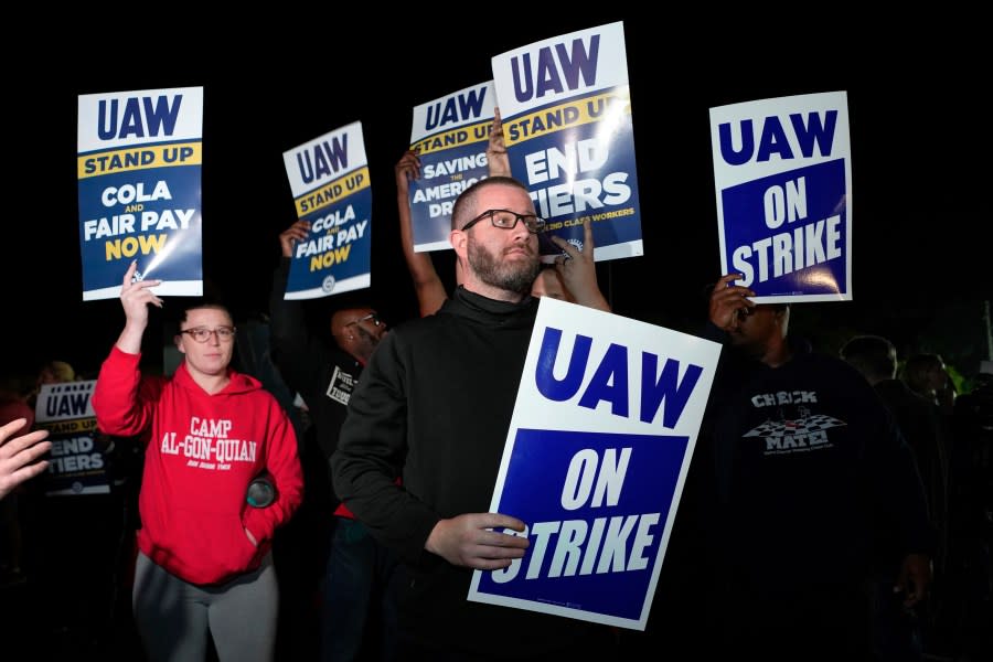 Striking United Auto Workers picket at Ford’s Michigan Assembly Plant in Wayne, Michigan, shortly after midnight on Friday, Sept. 15, 2023. (AP Photo/Paul Sancya)