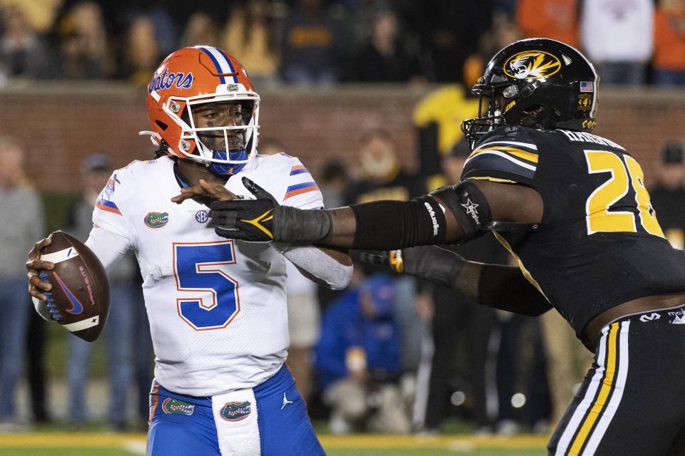 Florida quarterback Emory Jones, left, is sacked by Missouri defensive lineman Jatorian Hansford, right, during the fourth quarter of an NCAA college football game Saturday, Nov. 20, 2021, in Columbia, Mo. (AP Photo/L.G. Patterson)