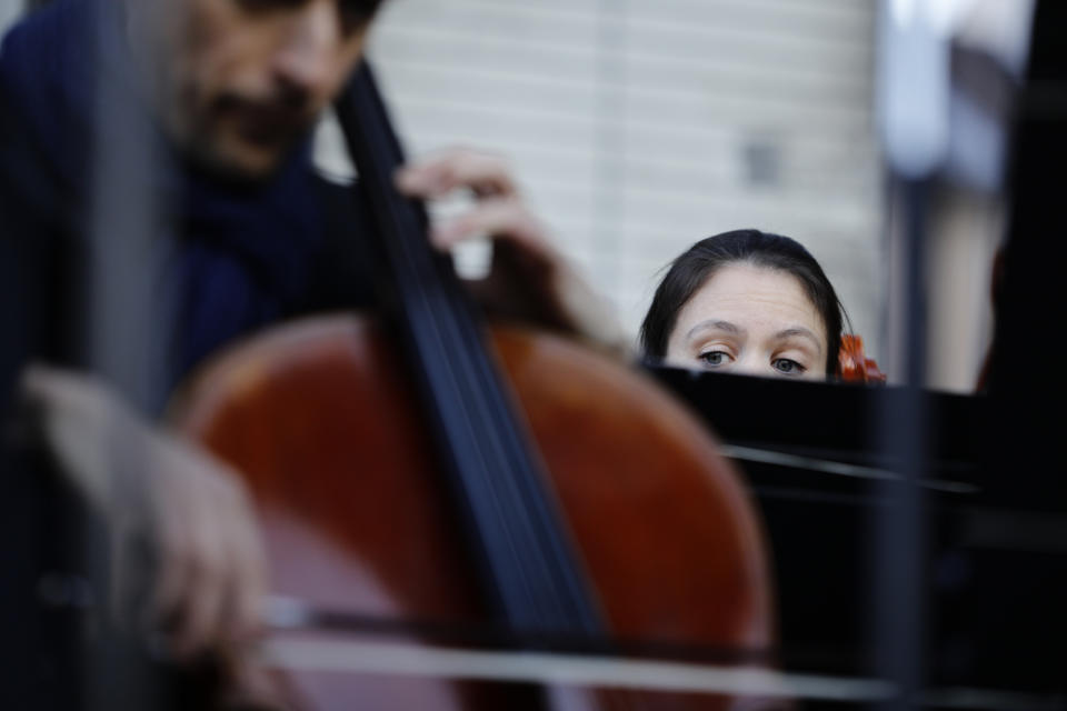 Striking musicians of the Paris Opera house perform outside the Bastille Opera house Tuesday, Dec. 31, 2019 in Paris. (AP Photo/Kamil Zihnioglu)