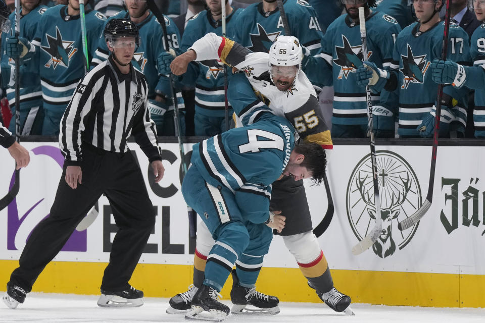 Vegas Golden Knights right wing Keegan Kolesar (55) fights with San Jose Sharks defenseman Kyle Burroughs (4) during the first period of an NHL hockey game in San Jose, Calif., Thursday, Oct. 12, 2023. (AP Photo/Jeff Chiu)