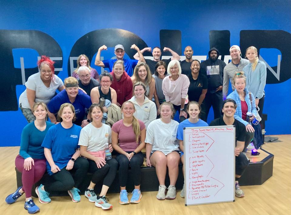 Participants of a 7 a.m. 600 Calorie Burn class led by All Elite Training owner Justin Rollins pose for a photograph after class. (JOSE FRANCO PHOTO)