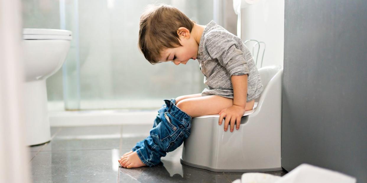 young kid sitting on potty chair