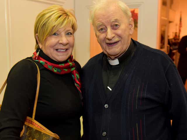 Melanie Brooks with Monsignor O'Neill at Carols for Cause at Christ Church in 2019.