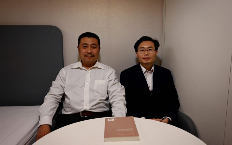 lawyers Ren Quanniu (L) and Zhang Keke, representing Chinese citizen journalist Zhang Zhan - AFP