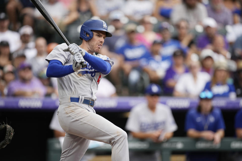 Los Angeles Dodgers' Freddie Freeman follows the flight of his RBI-double off Colorado Rockies relief pitcher Robert Stephenson in the seventh inning of a baseball game, Sunday, July 31, 2022, in Denver. (AP Photo/David Zalubowski)