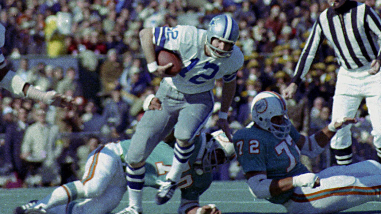Roger Staubach, Jim Riley Dallas Cowboys quarterback Roger Staubach (12) tries to escape the grasp of Miami Dolphins defender Jim Riley (70) during Super Bowl VI in New Orleans, La.