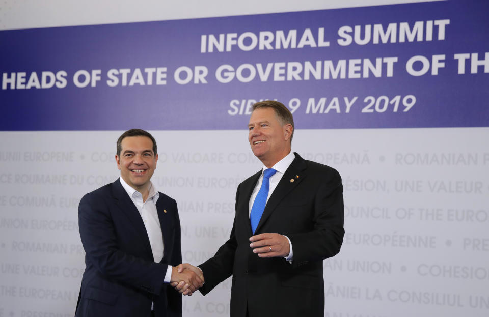 Greek Prime Minister Alexis Tsipras, left, is welcomed by Romanian President Klaus Werner Ioannis as he arrives for an EU summit in Sibiu, Romania, Thursday, May 9, 2019. European Union leaders on Thursday start to set out a course for increased political cooperation in the wake of the impending departure of the United Kingdom from the bloc. (AP Photo/Vadim Ghirda)