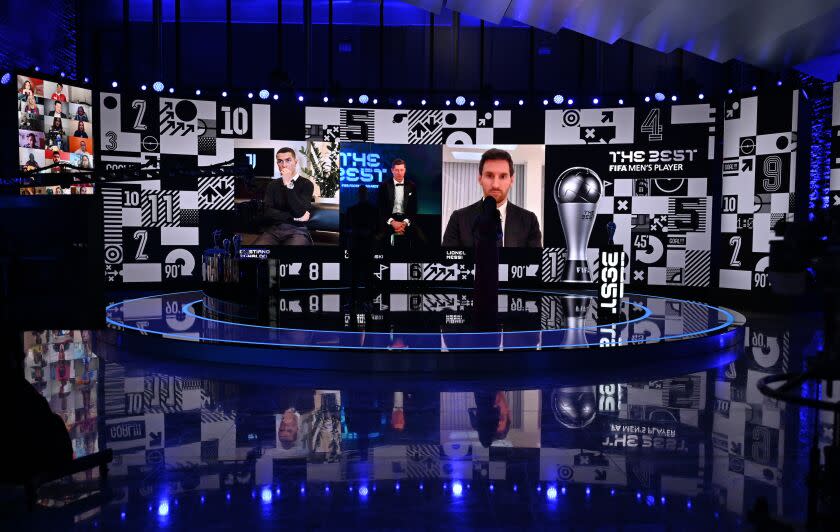 From left on the screen: Portugal's Cristiano Ronaldo, Poland's Robert Lewandowski and Argentina's Lionel Messi wait for hosts Reshmin Chowdhury, right, former Dutch soccer player Ruud Gullit, left, to announce the best player award during the Best FIFA Football Awards Ceremony in Zurich, Switzerland, Thursday, Dec. 17, 2020. (Valeriano Di Domenico/Pool via AP)