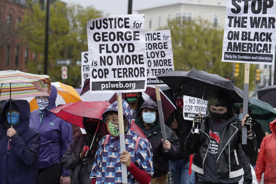 Demonstrators display placards while marching during a protest, Wednesday, April 21, 2021, in the Nubian Square neighborhood, of Boston, a day after a guilty verdict was announced at the trial of former Minneapolis police officer Derek Chauvin for the 2020 death of George Floyd. Chauvin has been convicted of murder and manslaughter in the death of Floyd. The demonstrators called for police reforms and racial equality. (AP Photo/Steven Senne)