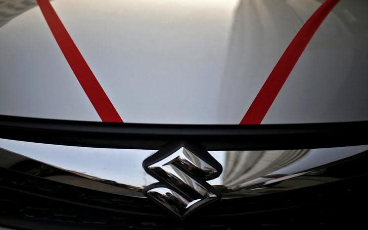 The logo of Maruti Suzuki India Limited is seen on car parked outside a showroom in New Delhi, India, February 29, 2016. REUTERS/Anindito Mukherjee/File Photo