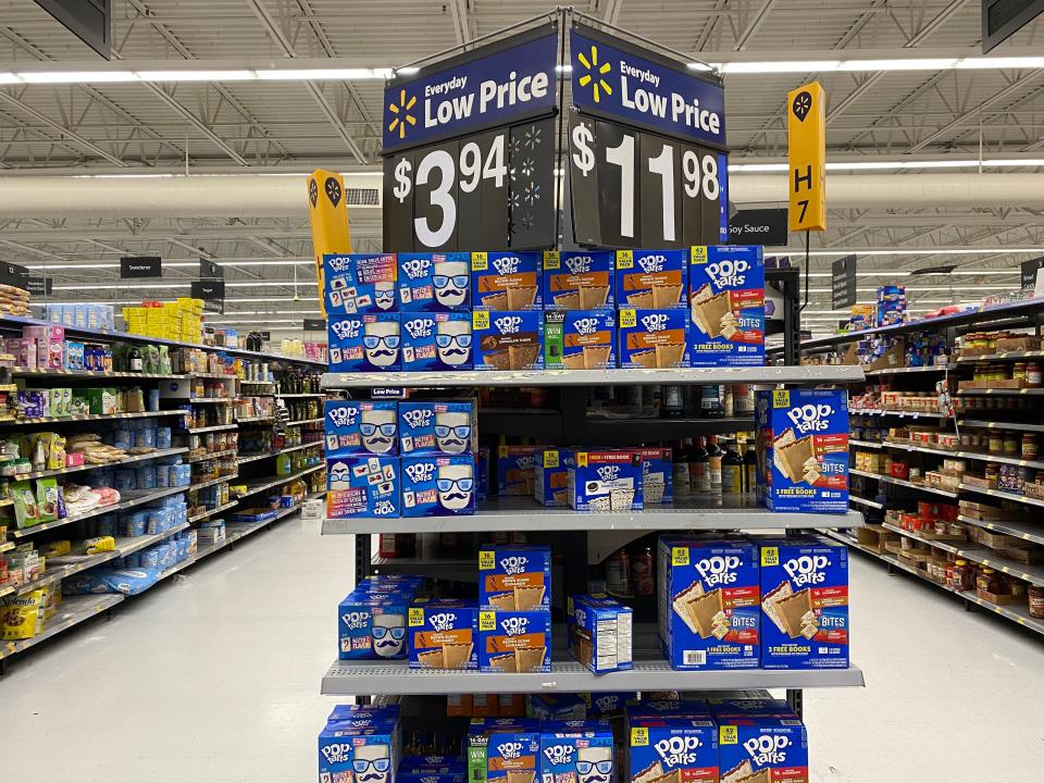 discount signs above a shelf of pop tarts at Walmart