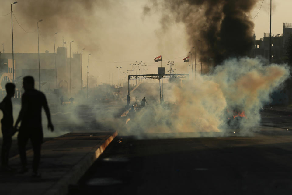 Anti-government protesters set fires and close a street during a demonstration in Baghdad, Iraq, Saturday, Oct. 5, 2019. The spontaneous protests which started Tuesday in Baghdad and southern cities were sparked by endemic corruption and lack of jobs. Security responded with a harsh crackdown, leaving more than 70 killed. (AP Photo/Hadi Mizban)