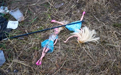 Toy dolls left after a police arid at a camp on the outskirts of Calais - Credit: Paul Grover