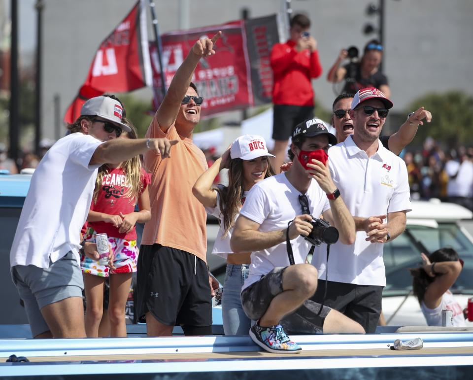 Tampa Bay Buccaneers NFL football quarterback Tom Brady, second from left, gesture as he and others celebrate their Super Bowl 55 victory over the Kansas City Chiefs with a boat parade in Tampa, Fla., Wednesday, Feb. 10, 2021. (Dirk Shadd/Tampa Bay Times via AP)