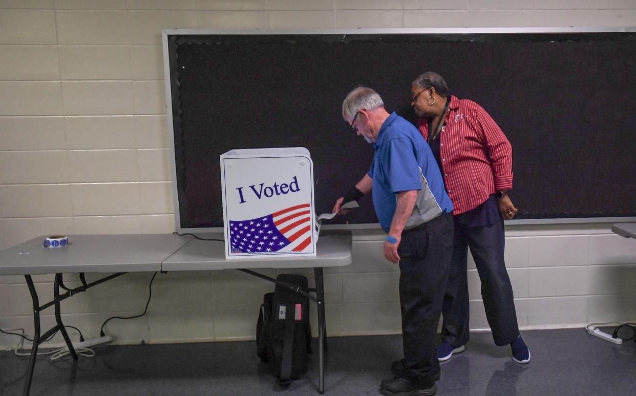 Sandra Vandiver, right, helps Jack Browning, 72, of Anderson vote during Primary Election Voting at the Southwood Academy of the Arts 5/B precinct in Anderson, S.C. Tuesday, June 11, 2024. "I always vote," said Browning. "A lot of them running I've know for years, I pretty much know their background."