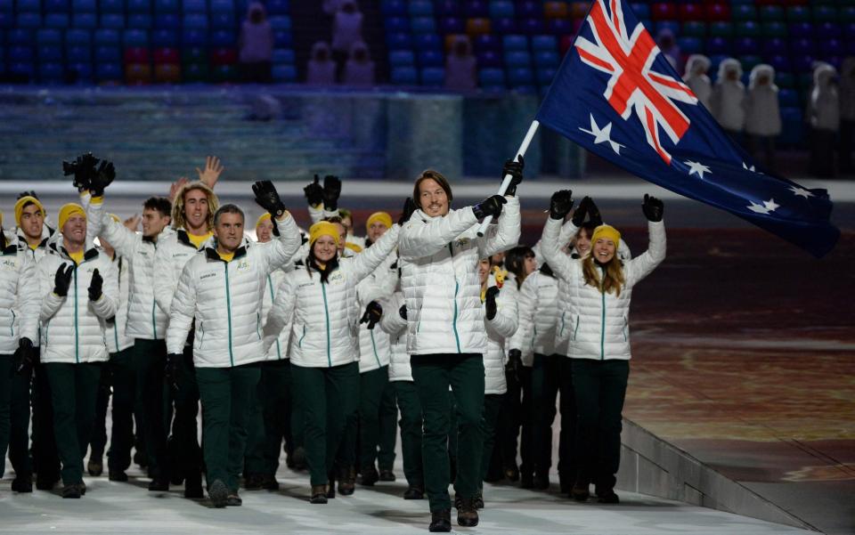 Alex Pullin waves the Australia flag at the 2014 Winter Olympics in Sochi - AFP