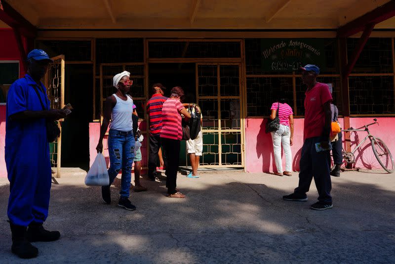 People line up in a market, in Santiago