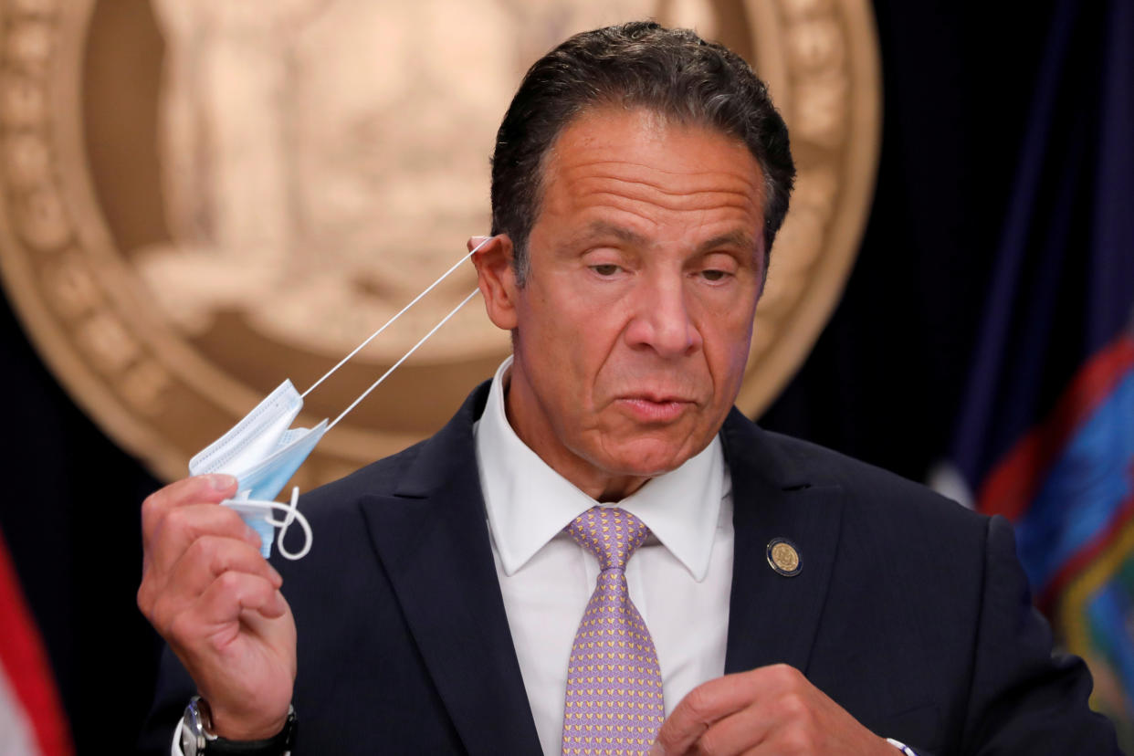 New York Governor Andrew Cuomo removes his protective face mask as he arrives to speak during a daily briefing following the outbreak of the coronavirus disease (COVID-19) in Manhattan in New York City, New York, U.S., July 13, 2020. REUTERS/Mike Segar     TPX IMAGES OF THE DAY