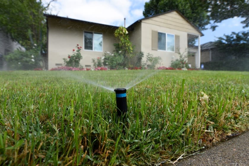 Sprinklers water the front lawn of a house on Zelzah Avenue in Encino.