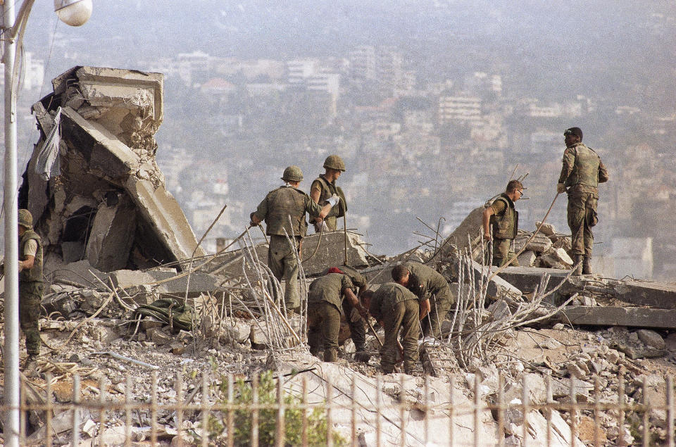 File - This is the scene around the U.S. Marine Base near Beirut Airport following a massive bomb blast that destroyed the base and caused a huge death, Oct. 23, 1983. Forty years after one of the deadliest attacks against U.S. troops in the Middle East, some warn that Washington could be sliding toward a new conflict in the region. (AP Photo/File)