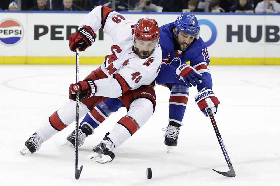Carolina Hurricanes left wing Jordan Martinook (48) and New York Rangers center Vincent Trocheck, right, battle for the puck in the second period during Game 5 of an NHL hockey Stanley Cup second-round playoff series Monday, May 13, 2024, in New York. (AP Photo/Adam Hunger)
